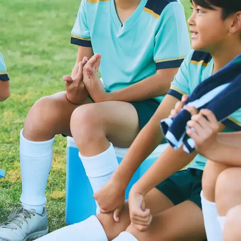 コールマン テイク9に座る小学生くらいの男子と小型クーラーボックスの使用イメージ