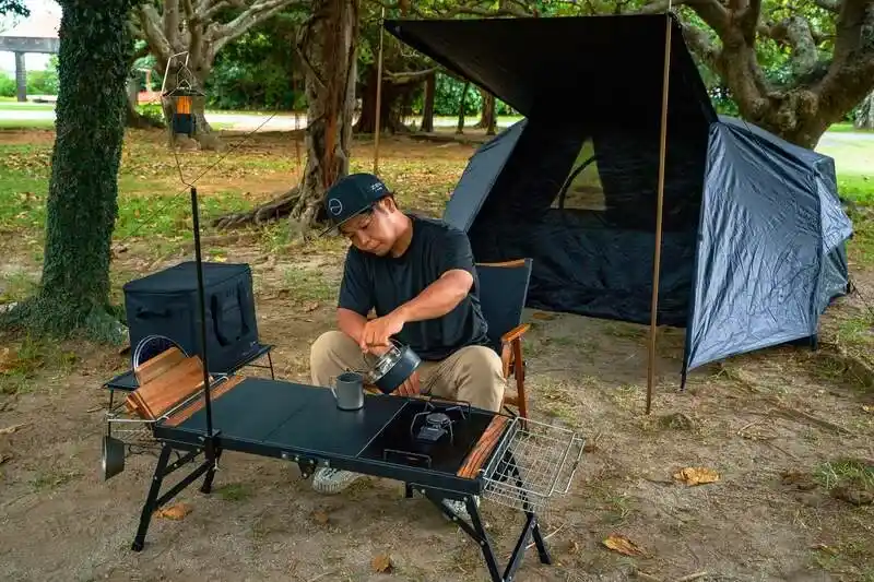 ZENキャンプ(ZEN Camps)のIGTテーブル『FoldFlex Table』にバスケットやランタンハンガーなどのオプションを取り付けている写真